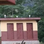 A three-door latrine block with fresh render