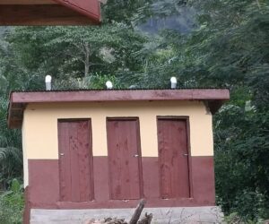 A three-door latrine block with fresh render