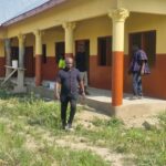 School building exterior with people near the entrance