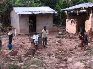 A mud-brick homestead with children nearby