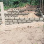 Partially built block wall foundation on cleared ground