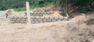 Partially built block wall foundation on cleared ground