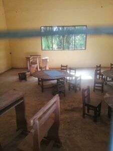 Empty classroom with small wooden chairs and tables