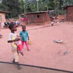 Children playing in a village street at dusk
